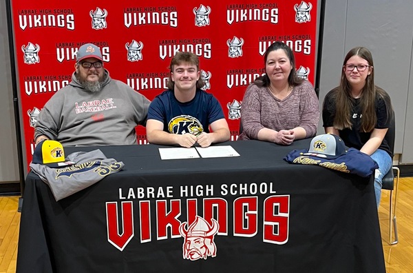 Brogan Collins signed a Letter of Intent surrounded by his father Eric, mother Brandy and his sister Bria.