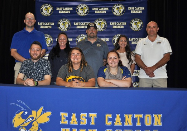 Signing a Letter of Intent is, Harley Mason (second from left) seated between her brother, Drew, and sister, Reagan . Looking on from the back row are Jason Hall, East Canton Head Softball Coach, Harley’s parents, Carrie and Brent Mason, Courtney Kennedy, East Canton Assistant Softball Coach, and Kent State Tuscarawas Head Softball Coach, Chuck Peach.