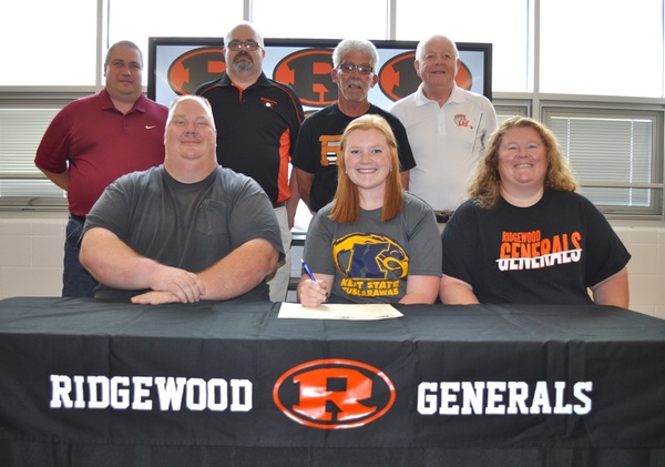 Signing a Letter of Intent is, Sadie Wilson (middle) seated between her father Tim and mother Heather. Looking on from the back row are Lester McCurdy, Ridgewood Girls Basketball Coach, Craig Reveal, Ridgewood Girls Golf Coach, Kirby Shivers, Ridgewood Softball Coach and Richard Reveal, Ridgewood Girls Assistant Golf Coach.