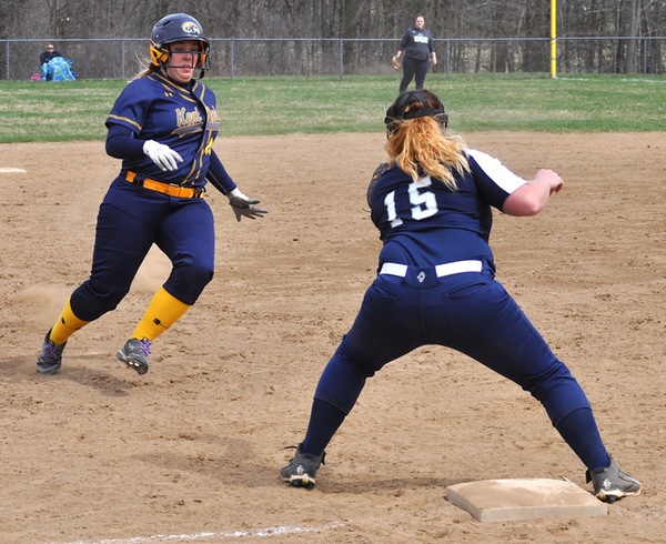 Madi Garrett attempts to take third base on a ball hit to the right side of the infield.