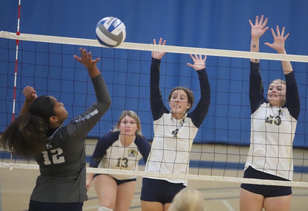 Addison Gordon (4) and Makenzie Ailes (23) block at the net versus Penn State Fayette.  (Photo by Rob Brindley)